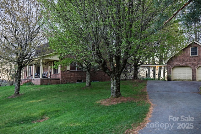 184 Buff Ridge Rd, Boone, NC 28607 - view of front of home with brick siding, asphalt driveway, a garage, and a front yard