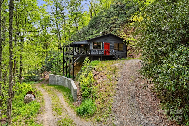 83 Snowy Cove Ln, Black Mountain, NC 28711 - view of front of house featuring driveway, a wooden deck, and a view of trees
