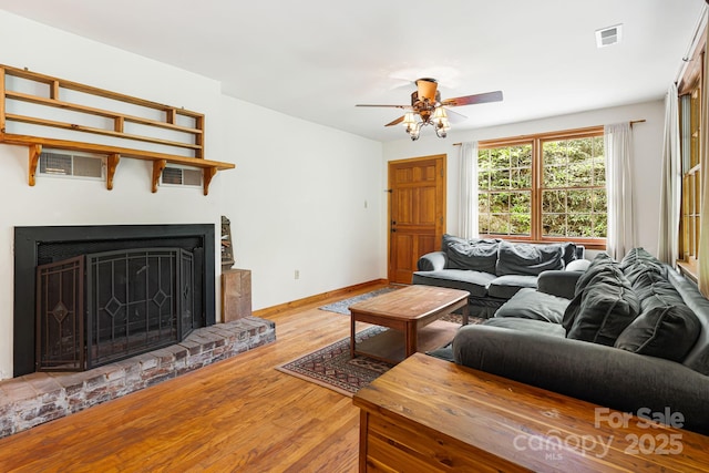 83 Snowy Cove Ln, Black Mountain, NC 28711 - living area featuring wood finished floors, ceiling fan, baseboards, and a brick fireplace
