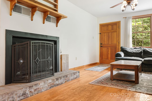 83 Snowy Cove Ln, Black Mountain, NC 28711 - living area featuring wood finished floors, a ceiling fan, baseboards, and a fireplace with raised hearth