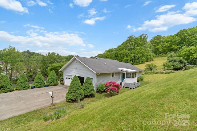 17 Gun Flint Dr, Burnsville, NC 28714 - view of side of property featuring a garage, a lawn, and driveway