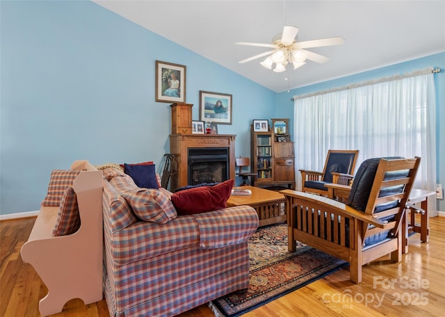 17 Gun Flint Dr, Burnsville, NC 28714 - living room with vaulted ceiling, ceiling fan, wood finished floors, a fireplace, and baseboards
