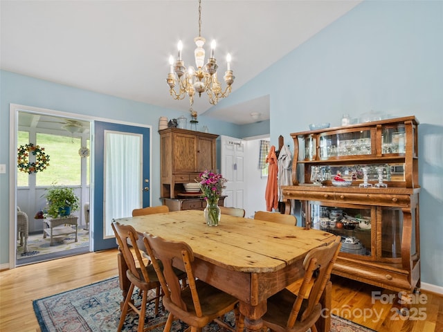17 Gun Flint Dr, Burnsville, NC 28714 - dining space with a chandelier, lofted ceiling, and light wood-style flooring