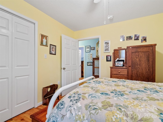 17 Gun Flint Dr, Burnsville, NC 28714 - bedroom with light wood finished floors, a closet, a ceiling fan, and baseboards