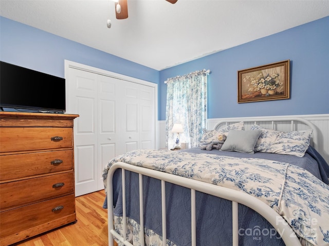 17 Gun Flint Dr, Burnsville, NC 28714 - bedroom featuring a closet, a wainscoted wall, light wood finished floors, and ceiling fan