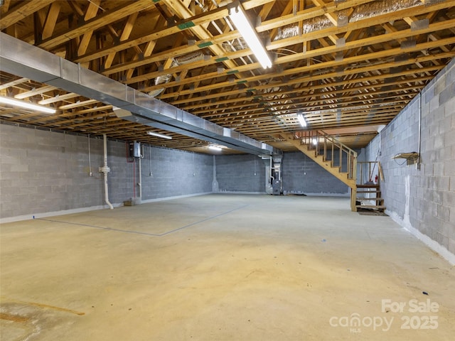 17 Gun Flint Dr, Burnsville, NC 28714 - unfinished below grade area with concrete block wall, stairs, and heating unit