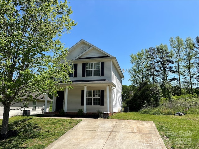 traditional home featuring covered porch, a front lawn, and cooling unit