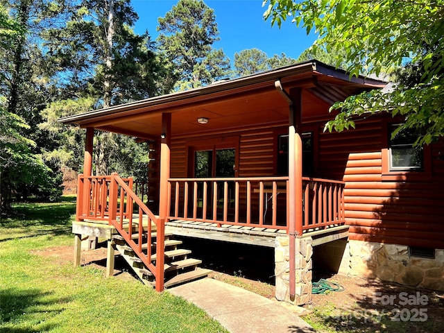 view of front facade with a front lawn and a wooden deck