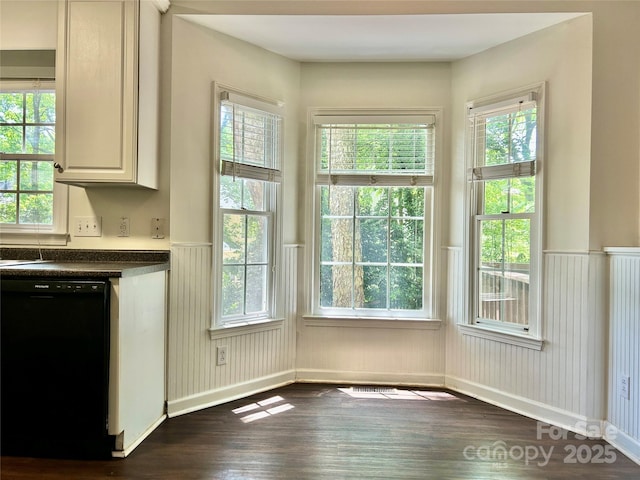 9907 Furlong Trl, Charlotte, NC 28269 - unfurnished dining area with a wainscoted wall, dark wood-type flooring, and healthy amount of natural light