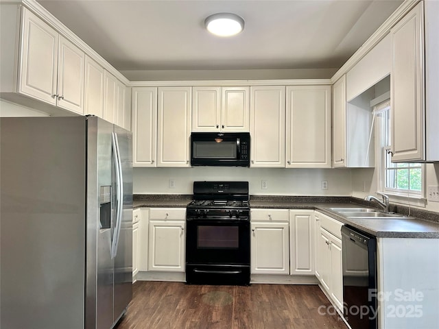 9907 Furlong Trl, Charlotte, NC 28269 - kitchen with black appliances, a sink, dark countertops, dark wood-style flooring, and white cabinets