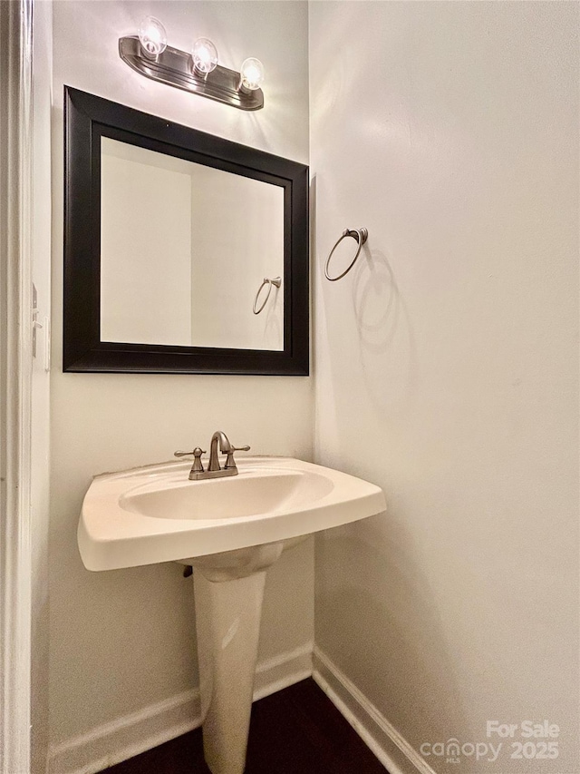 9907 Furlong Trl, Charlotte, NC 28269 - bathroom with baseboards and a sink