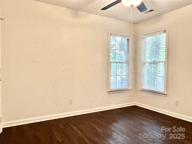 9907 Furlong Trl, Charlotte, NC 28269 - empty room featuring baseboards, dark wood-type flooring, healthy amount of natural light, and ceiling fan