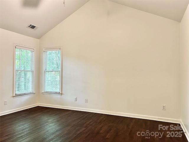 9907 Furlong Trl, Charlotte, NC 28269 - spare room with lofted ceiling, dark wood-style floors, and baseboards