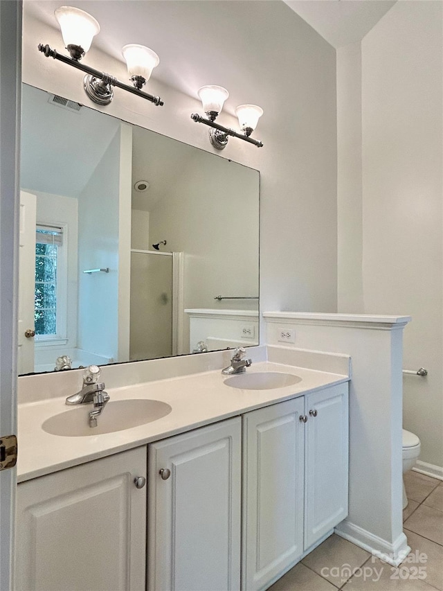 9907 Furlong Trl, Charlotte, NC 28269 - bathroom featuring tile patterned flooring, a stall shower, double vanity, and toilet