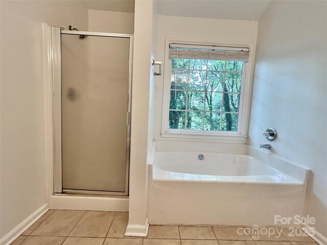 9907 Furlong Trl, Charlotte, NC 28269 - full bathroom featuring tile patterned floors, a stall shower, a bath, and baseboards