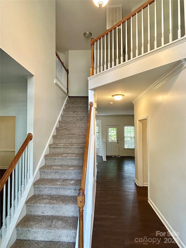 9907 Furlong Trl, Charlotte, NC 28269 - stairway with crown molding, wood finished floors, baseboards, and a towering ceiling