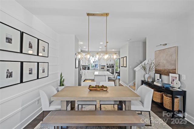 dining area featuring dark wood-type flooring, baseboards, and recessed lighting
