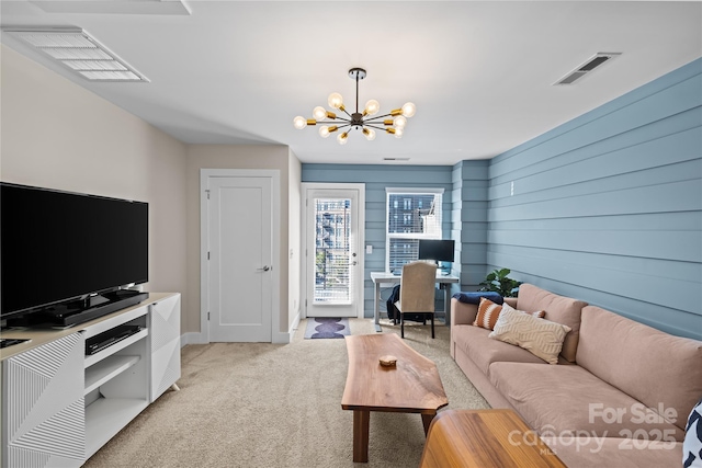 living area featuring light colored carpet, a chandelier, an office area, and baseboards
