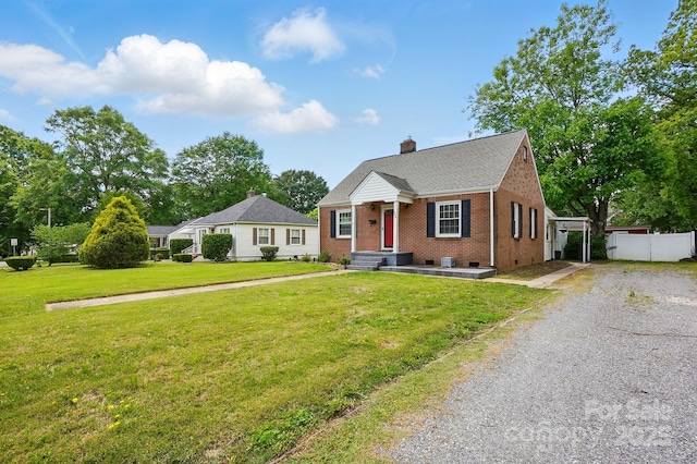 bungalow-style home featuring fence, a chimney, brick siding, and a front yard