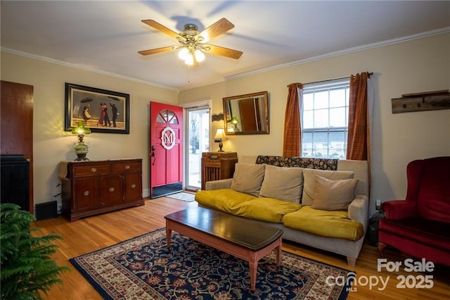 living area featuring crown molding, a ceiling fan, and wood finished floors