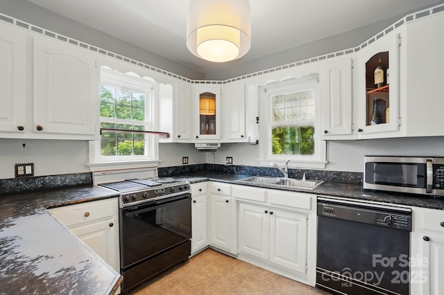 kitchen featuring a sink, black dishwasher, electric range, white cabinetry, and stainless steel microwave