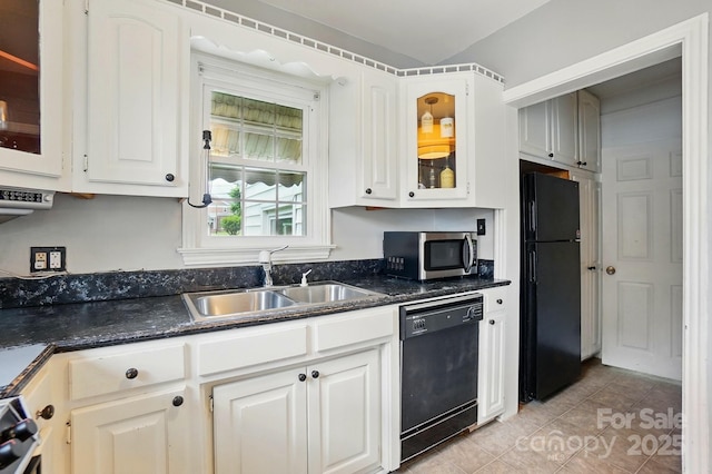 kitchen featuring glass insert cabinets, light tile patterned floors, a sink, white cabinetry, and black appliances