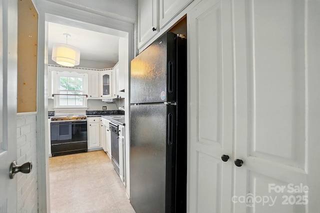kitchen featuring freestanding refrigerator, dishwasher, white cabinetry, electric range, and dark countertops
