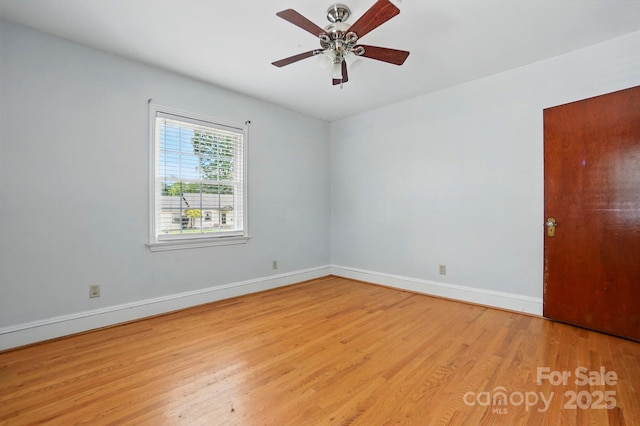 unfurnished room featuring wood finished floors, baseboards, and ceiling fan