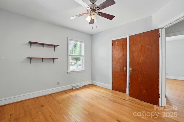 unfurnished bedroom with ceiling fan, baseboards, light wood-type flooring, and visible vents