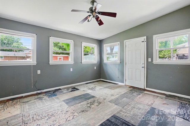 spare room with lofted ceiling, baseboards, a ceiling fan, and wood finished floors