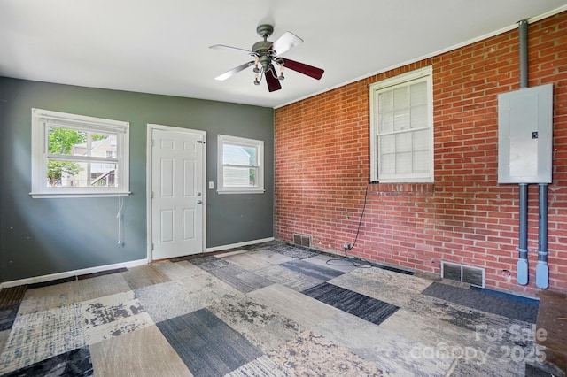 entrance foyer featuring electric panel, a healthy amount of sunlight, baseboards, and ceiling fan
