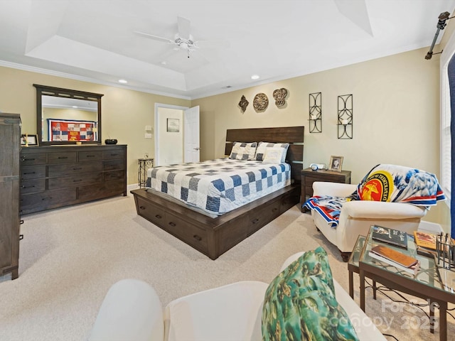 bedroom with ornamental molding, recessed lighting, ceiling fan, carpet floors, and a tray ceiling