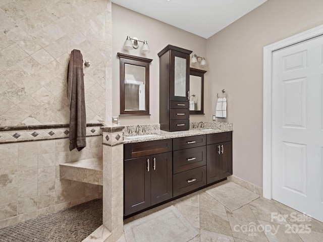full bath with walk in shower, double vanity, and a sink