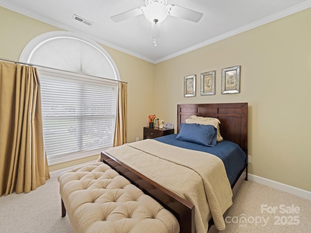 bedroom with carpet floors, crown molding, visible vents, baseboards, and ceiling fan