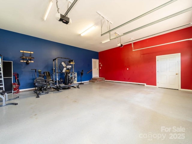 garage with baseboards and a garage door opener