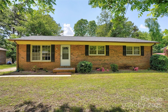 ranch-style home with a front lawn and brick siding