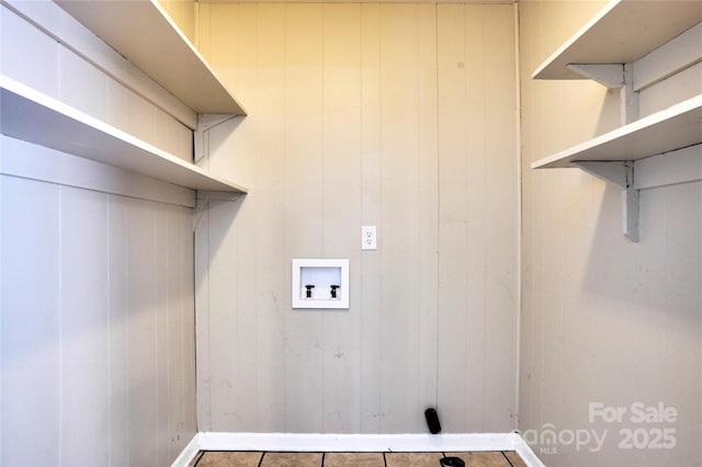 laundry area with hookup for a washing machine and baseboards