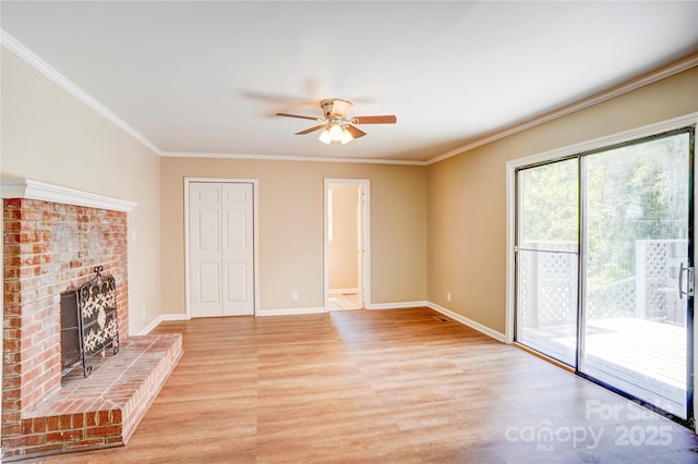unfurnished living room with light wood-style floors, a ceiling fan, baseboards, crown molding, and a fireplace