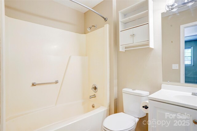 bathroom with toilet, vanity, and shower / bath combination