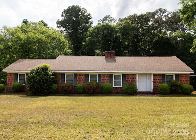 single story home featuring brick siding, a front lawn, and a chimney