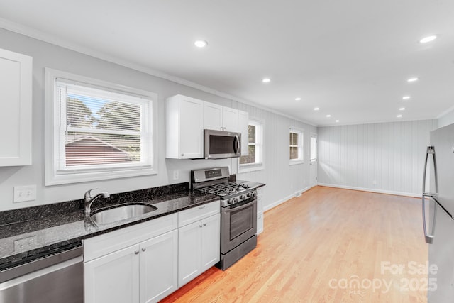 2001 Tyvola Rd, Charlotte, NC 28210 - kitchen with appliances with stainless steel finishes, crown molding, light wood-style floors, white cabinetry, and a sink