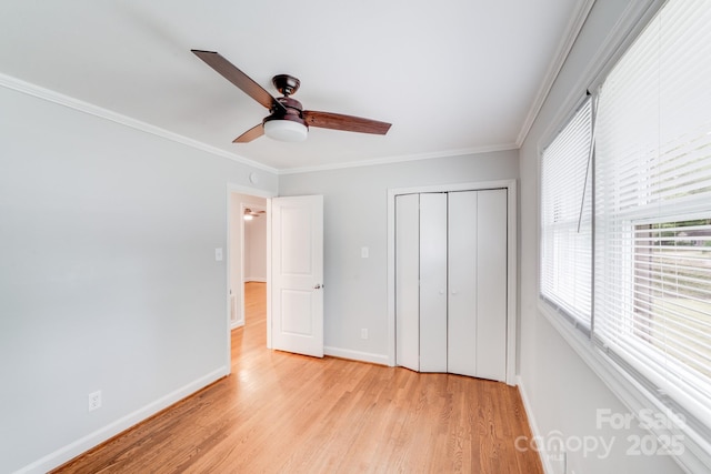 2001 Tyvola Rd, Charlotte, NC 28210 - unfurnished bedroom featuring a closet, light wood-style floors, baseboards, ornamental molding, and a ceiling fan
