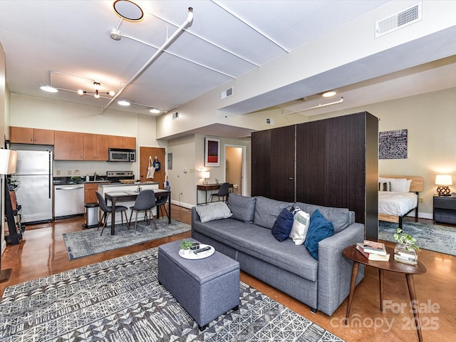 living room featuring baseboards and concrete floors