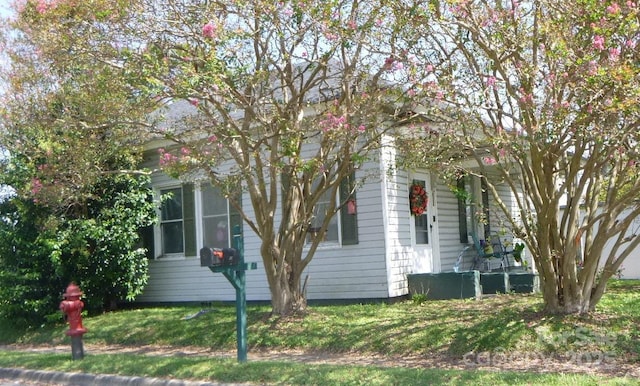 view of side of property with a yard