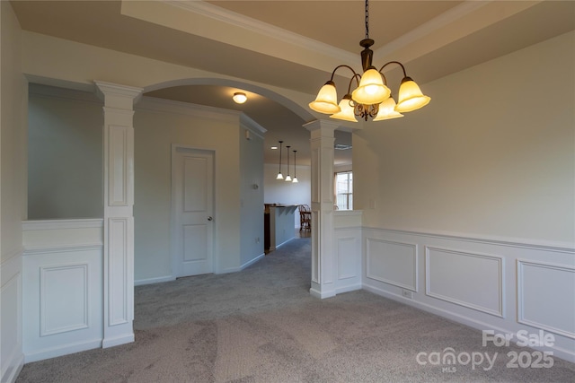 159 Saye Pl, Mooresville, NC 28115 - empty room featuring ornate columns, arched walkways, light carpet, ornamental molding, and a decorative wall