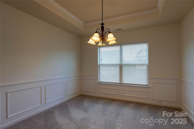159 Saye Pl, Mooresville, NC 28115 - empty room with a chandelier, a raised ceiling, a wainscoted wall, a decorative wall, and crown molding