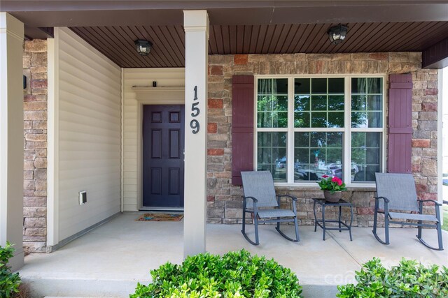 159 Saye Pl, Mooresville, NC 28115 - view of exterior entry featuring a porch and stone siding