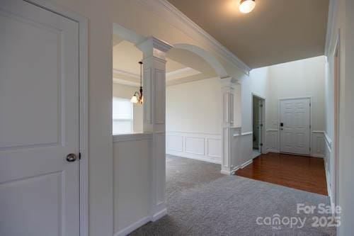 159 Saye Pl, Mooresville, NC 28115 - corridor featuring ornate columns, arched walkways, carpet, ornamental molding, and a decorative wall