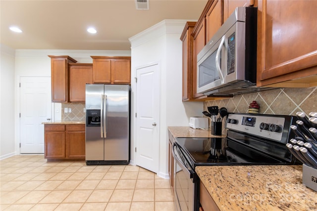159 Saye Pl, Mooresville, NC 28115 - kitchen featuring stainless steel appliances, brown cabinets, tasteful backsplash, light stone counters, and light tile patterned flooring
