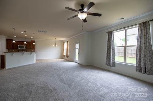 159 Saye Pl, Mooresville, NC 28115 - unfurnished living room featuring crown molding, ceiling fan, and light colored carpet